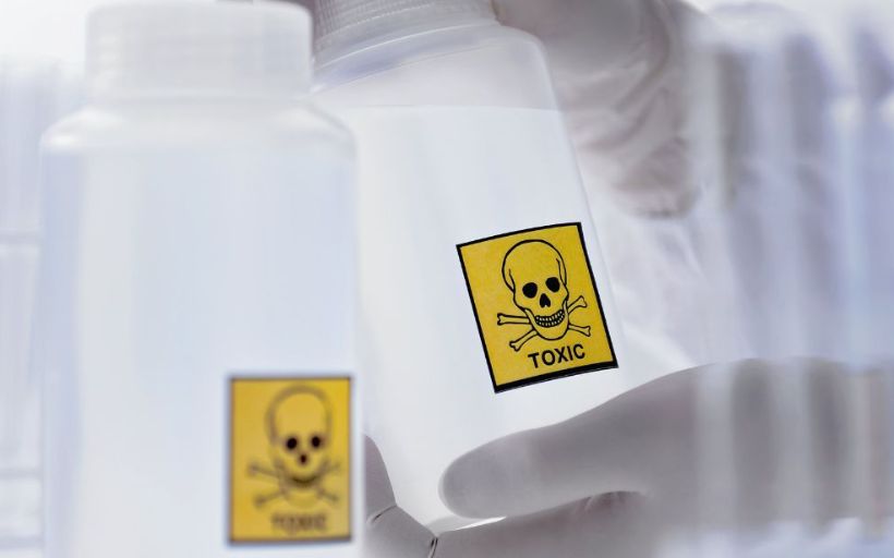 Scientist Holding Bottle with Toxic Label 3