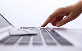 Close up of hand on computer keyboard
