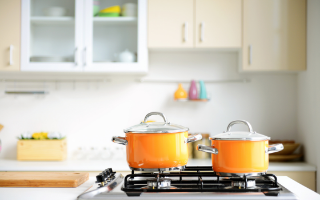 orange cooking pan on stove in modern kitchen