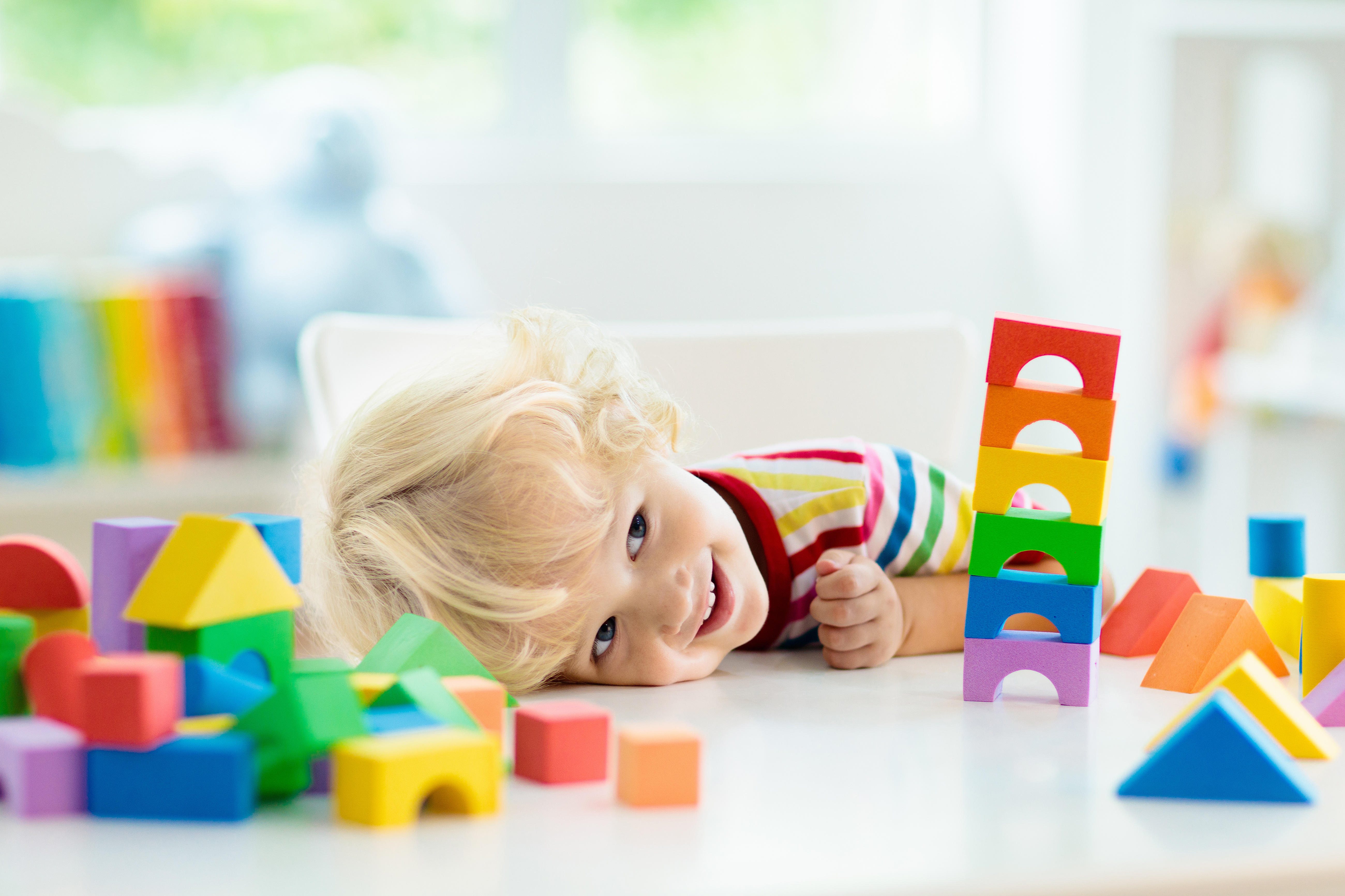 Child Building Tower of Toy Blocks