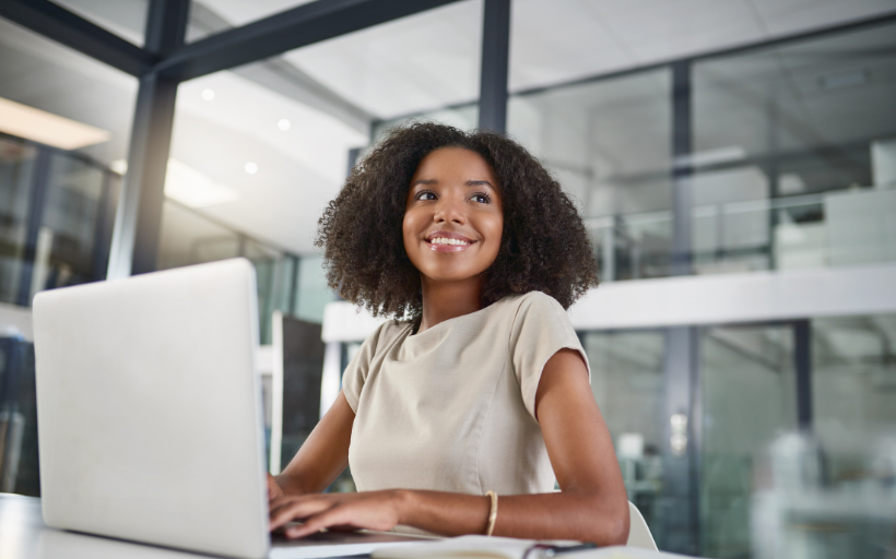 Low Angle of Businesswoman Working on a Laptop in Her Office
