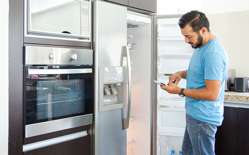 Man Standing Infront of an Open Fridge