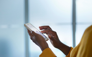 Person wearing yellow using cellphone