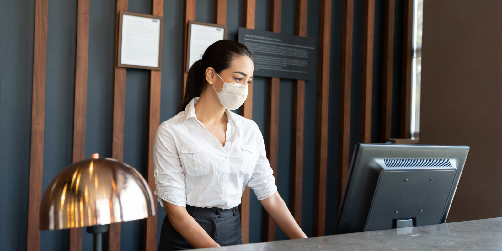Receptionist Working in Hotel Wearing Face Mask