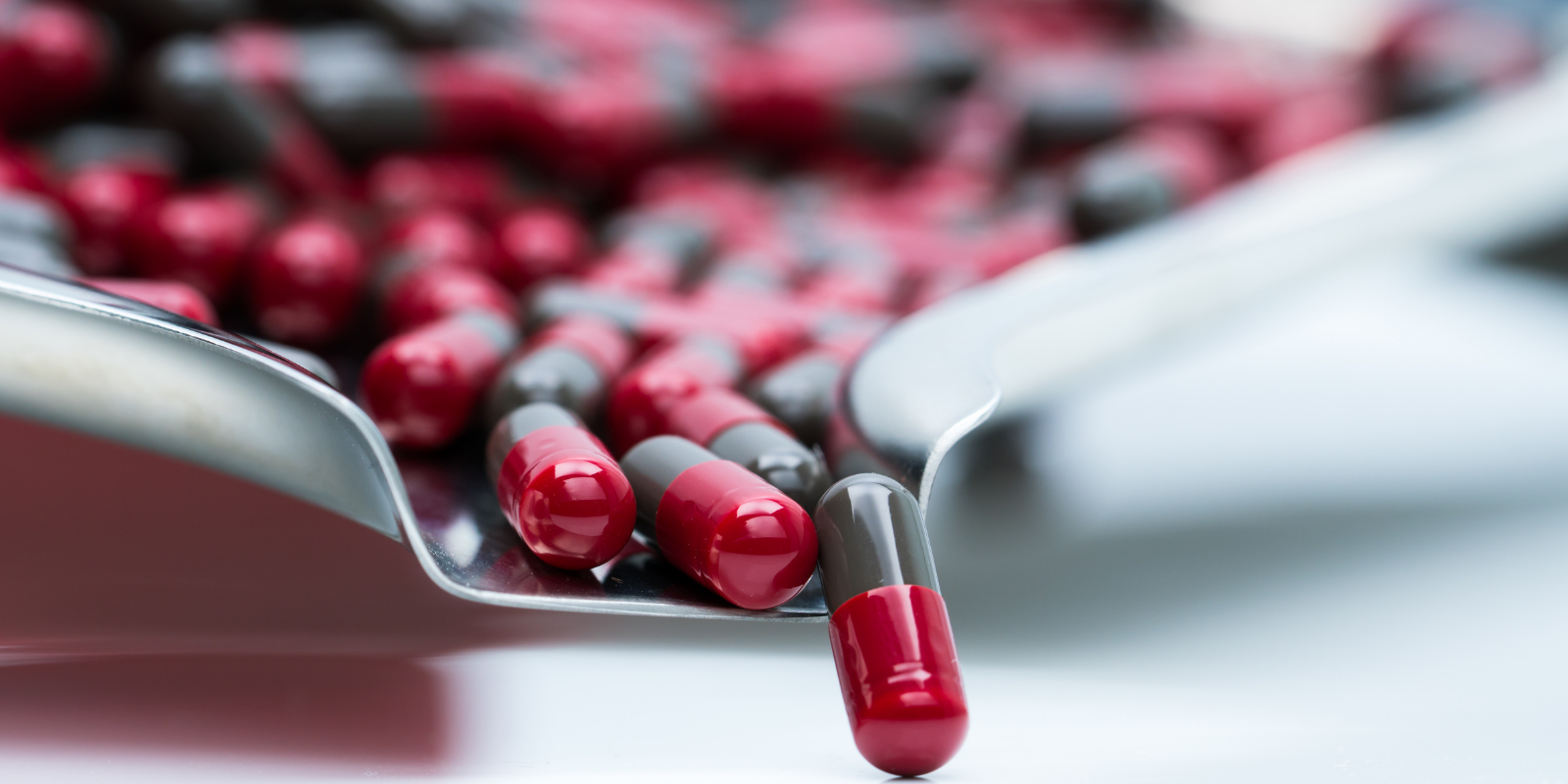 Red and gray capsule in a capsule counter tray