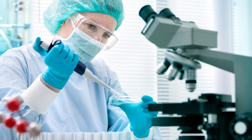 Lab worker holding a petri dish