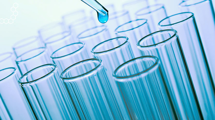 Dropping blue substance into test tubes from pipette